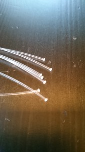 Fiber optic strands, showing the "nail head" after being touched to the soldering iron.